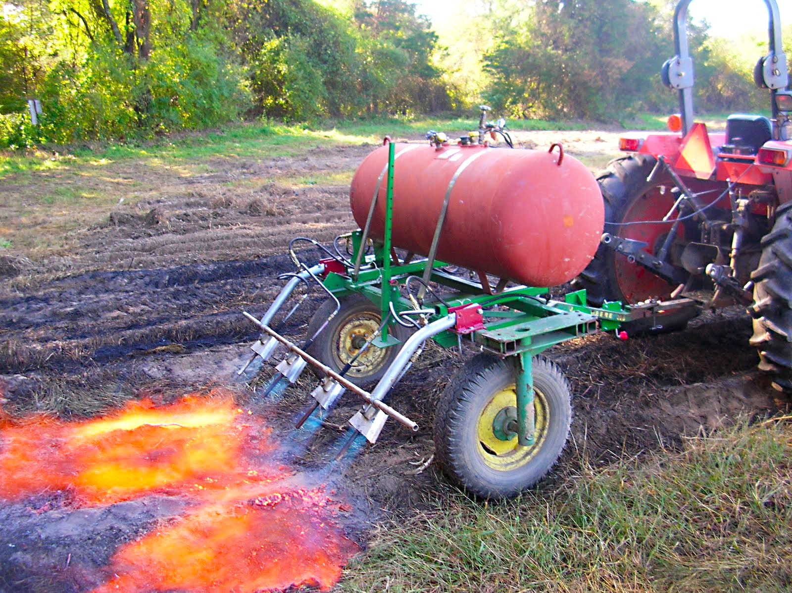 A tractor-mounted fl ame weeder in operation at Holcomb Farm in Connecticut.