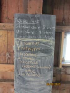 A chalkboard at the CSA pickup site